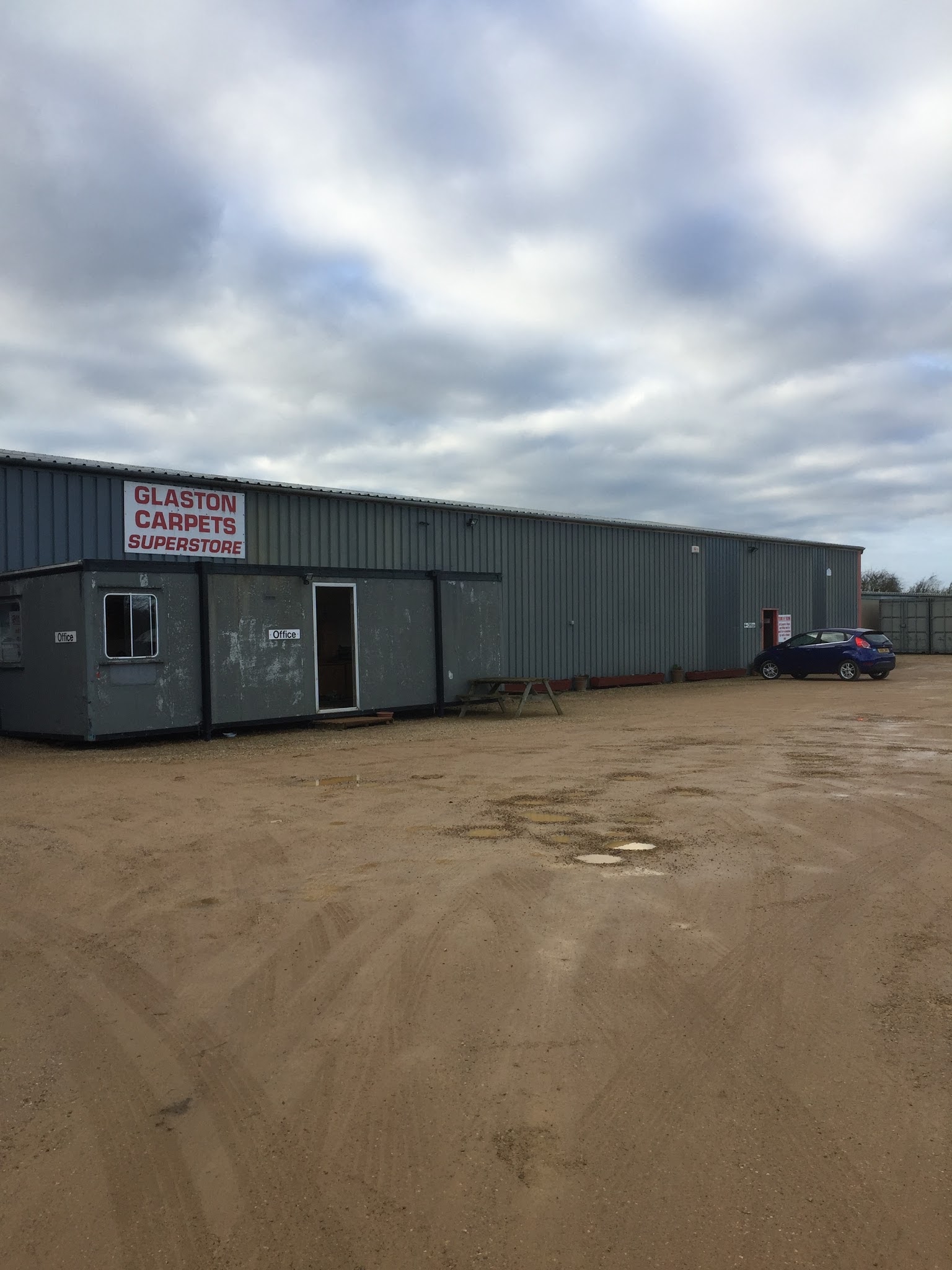 The Glaston Carpets Superstore sign on the warehouse