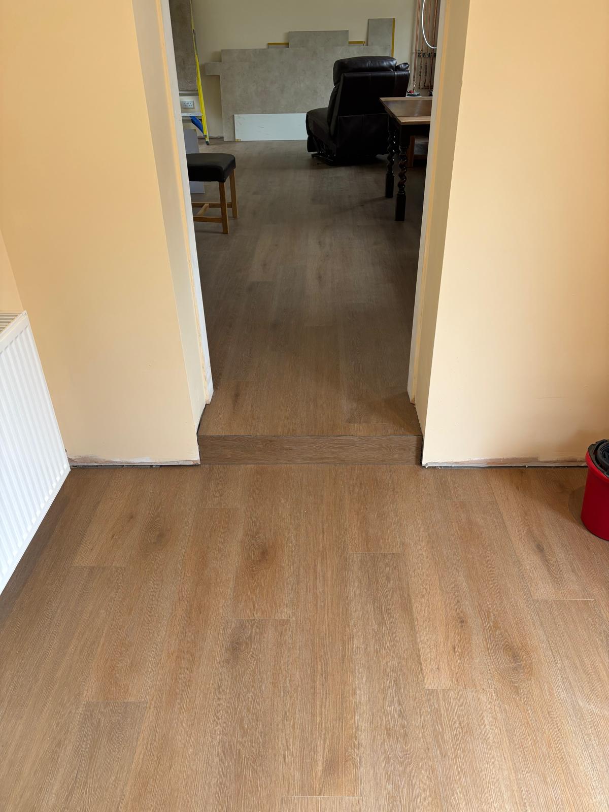 Wood effect flooring laid through a doorway