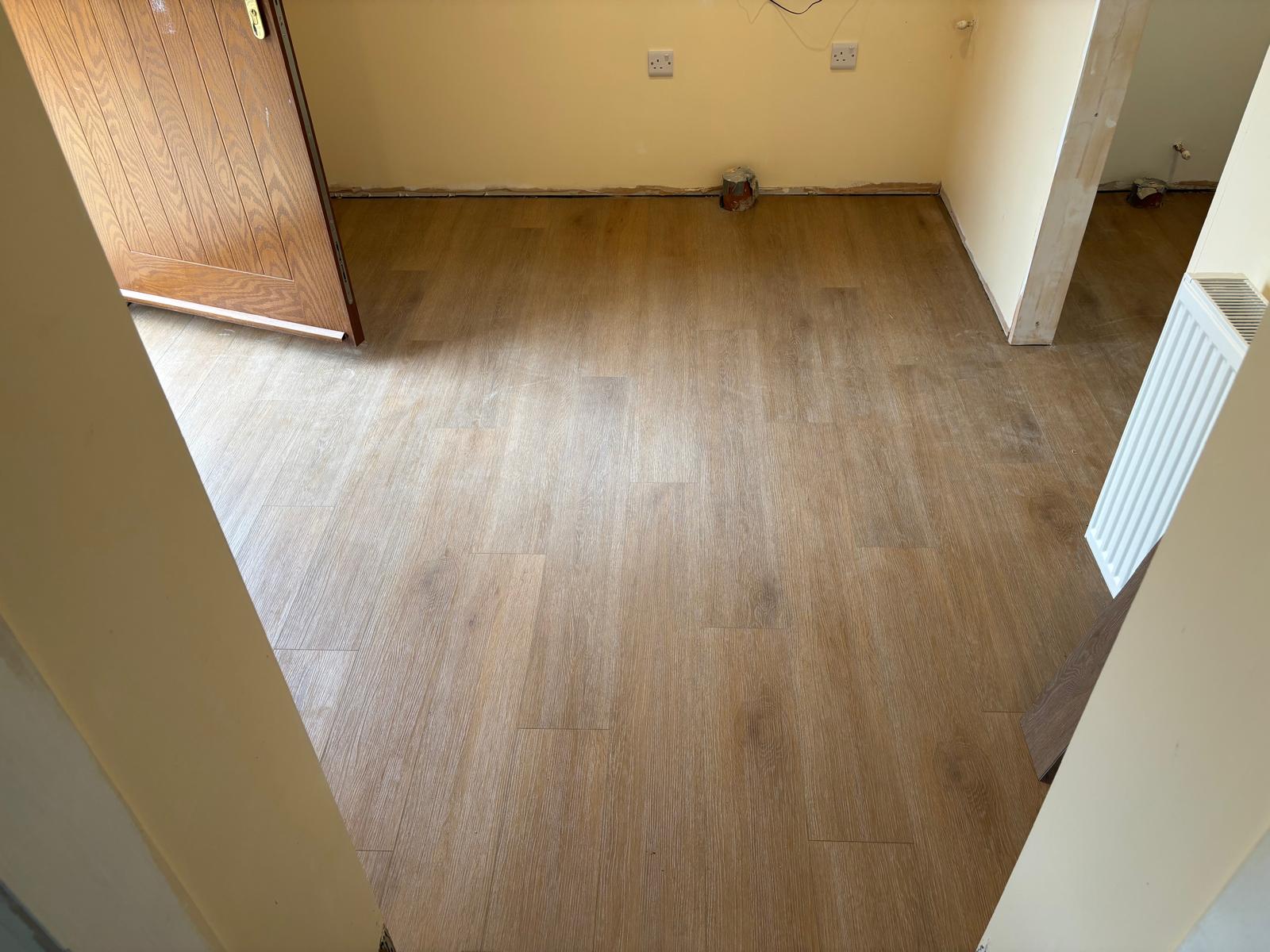 Wood effect flooring laid in an empty room